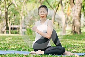 Young asian woman yoga outdoors keep calm and meditates while practicing yoga to explore the inner peace.