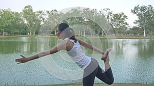Young asian woman yoga outdoors keep calm and meditates while practicing yoga to explore the inner peace.