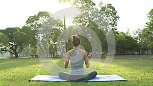 Young asian woman yoga outdoors keep calm and meditates while practicing yoga to explore the inner peace.