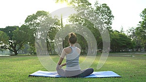 Young asian woman yoga outdoors keep calm and meditates while practicing yoga to explore the inner peace.