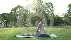 Young asian woman yoga outdoors keep calm and meditates while practicing yoga to explore the inner peace.