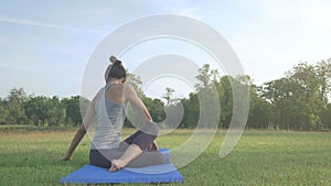 Young asian woman yoga outdoors keep calm and meditates while practicing yoga to explore the inner peace.