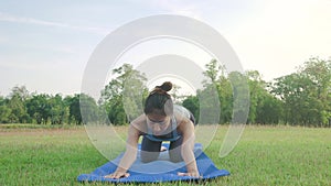 Young asian woman yoga outdoors keep calm and meditates while practicing yoga to explore the inner peace.