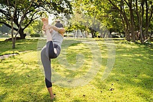 Young asian woman yoga outdoors keep calm and meditates while practicing yoga to explore the inner peace. Yoga have good benefits