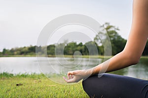 Young asian woman yoga outdoors keep calm and meditates while practicing yoga to explore the inner peace. Yoga have good benefits