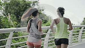 young asian women female friends running jogging exercising outdoors