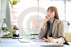 Young Asian Women graphic designer working with diagrams color and computer graphic at office