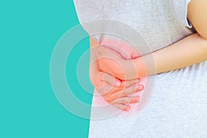 Young asian women hold hands in painful areas which may be caused by gastritis, menstruation period cramp, abdominal pain, stomach photo
