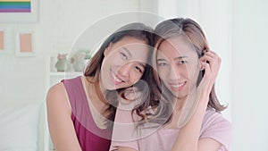 Young Asian women lesbian happy couple smiling and looking to camera while relax in her bedroom at home.