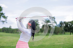Young asian women player golf swing shot in golf course on the hill