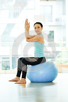 Young asian women practicing yoga ball, fitness stretching flexibility pose, working out, healthy lifestyle, wellness, well being