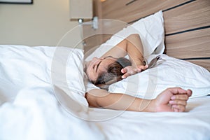 Young asian women stretching in bed after wake up