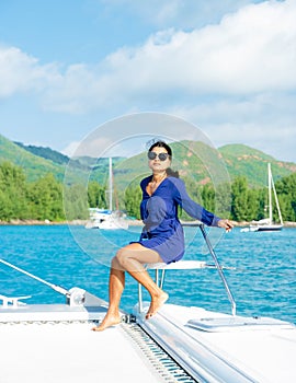 Young Asian women on a trip with a Sailing boat at the Tropical Seychelles Islands