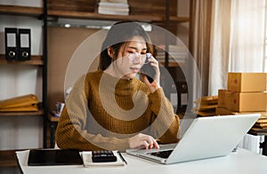 young asian women using smartphone contacted a customer asking for a shipping address