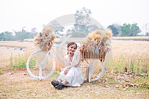 Young Asian women in white dresses in the Barley rice field