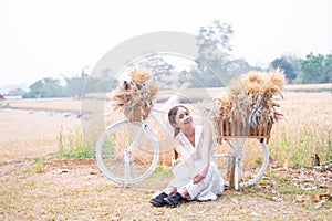 Young Asian women in white dresses in the Barley rice field