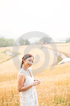 Young Asian women in white dresses in the Barley rice field