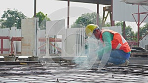 Young asian worker using machine welding iron with hands working in industrial factory, welder man or labor welding joint steel.