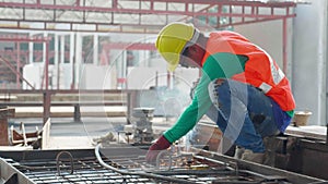 Young asian worker using machine welding iron with hands working in industrial factory, welder man or labor welding joint steel.