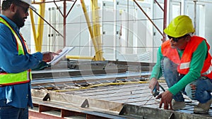 Young asian worker using machine welding iron with hands working while supervisor examining in industrial factory, welder man or