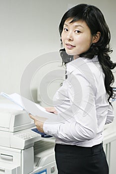 Young asian working with print photo