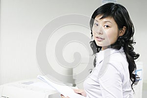 Young asian working with print photo