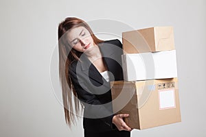 Young Asian working woman with 3 heavy shipping boxes