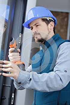 young assembly worker mounted window