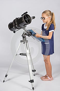 Young astronomer with glasses writes observations