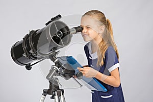 The young astronomer happy to look through the telescope recording observations