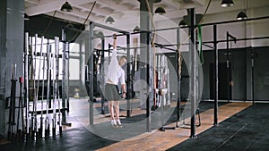 Young athlete doing exercises on the bar