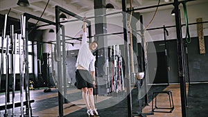 Young athlete doing exercises on the bar