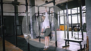 Young athlete doing exercises on the bar