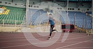 Young athlete leaping over barriers