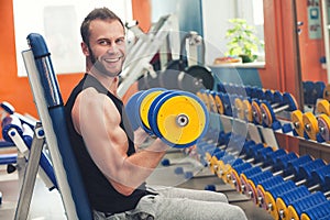 Young athlete lifting weights in the gym photo