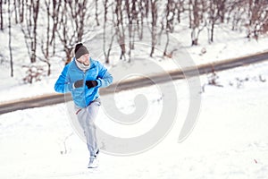 Young athlete man running on snow for a healthy training