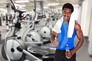 Young athlete man showing thumb up gesture at gym