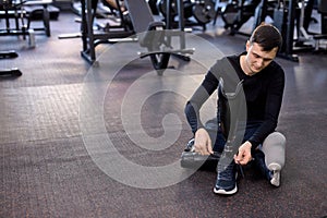 young athlete putting on sneakers on his artificial leg