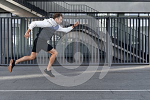 Young athlete running fast and training outdoors