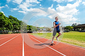 Young athlete runs on a treadmill at the stadium