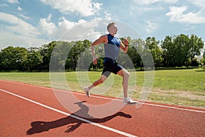 Young athlete runs on a treadmill at the stadium