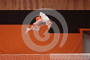 Young athlete on the trampoline in graceful flight.