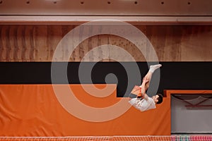 Young athlete on the trampoline in graceful flight.