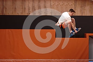 Young athlete on the trampoline in graceful flight.