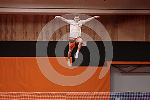 Young athlete on the trampoline in graceful flight.