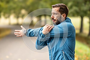 A young athlete is warming up before running training in the park