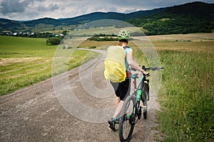 Young athlete woman with bicycle in the nature.