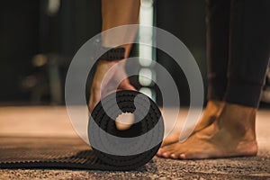 Young athlete woman practicing yoga and meditating indoors. Beautiful girl preparing material for practice class. Calmness and