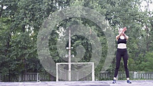 Young Athlete Woman in Sport Outfit Engaged in Fitness on the Sports Field in the Park.