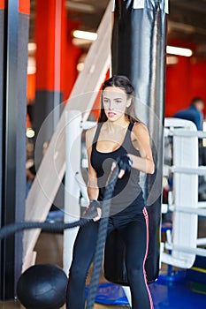 Young athletes girl does exercises at the gym. Sport concept.